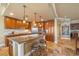 Open-concept kitchen featuring a center island with seating, granite countertops, and stainless steel appliances at 20 Via Mantova # 306, Henderson, NV 89011