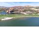Aerial view of lakefront resort with red-tile roofs, pools, golf course, and serene water features at 20 Via Mantova # 306, Henderson, NV 89011