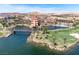 Scenic lake view featuring lush golf course, a charming bridge, and elegant resort architecture at 20 Via Mantova # 306, Henderson, NV 89011