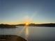 Breathtaking lake view at sunrise, showcasing the sun rising over distant mountains and reflecting on the water at 20 Via Mantova # 306, Henderson, NV 89011