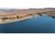 Expansive lake view featuring condos, a pool, private docks, and mountain landscape, emphasizing luxury lake living at 20 Via Mantova # 306, Henderson, NV 89011