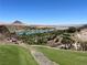 Scenic lake view from property showcasing verdant golf course, water and distant mountains at 20 Via Mantova # 306, Henderson, NV 89011