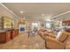 Elegant living room with a fireplace, travertine floors, crown molding and a beautiful view at 20 Via Mantova # 306, Henderson, NV 89011