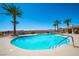 Beautiful community pool surrounded by palm trees and lounge chairs under a bright sky at 20 Via Mantova # 306, Henderson, NV 89011