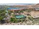Aerial view of community tennis courts near lakeside homes, offering recreational amenities with scenic views at 20 Via Mantova # 306, Henderson, NV 89011