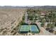 Aerial view of community tennis courts near desert, offering recreational amenities and activity at 20 Via Mantova # 306, Henderson, NV 89011