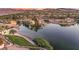 Scenic waterfront homes with palm trees and lush greenery along a serene lake, offering picturesque views at 20 Via Mantova # 306, Henderson, NV 89011