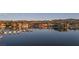 Still water reflects luxury waterfront homes with docks, creating a serene lakeside living environment at 20 Via Mantova # 306, Henderson, NV 89011