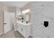 Bathroom featuring dual sinks, white vanity with marble countertops and modern fixtures at 2007 Cutlass Dr # 0, Henderson, NV 89014