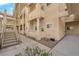 Low angle view of the condo building with stairs and beige stucco exterior at 2007 Cutlass Dr # 0, Henderson, NV 89014