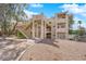 Multi-level condo building with beige exterior, open stairways, and landscaped grounds at 2007 Cutlass Dr # 0, Henderson, NV 89014