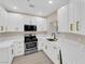 Modern kitchen featuring white cabinets, stainless steel appliances, and elegant marble countertops at 2007 Cutlass Dr # 0, Henderson, NV 89014