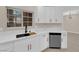 Elegant kitchen with white cabinets, marble countertops, stainless steel appliances and black faucet at 2007 Cutlass Dr # 0, Henderson, NV 89014