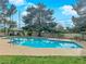 Sparkling community pool surrounded by lounge chairs, mature trees, and a gazebo at 2007 Cutlass Dr # 0, Henderson, NV 89014