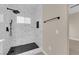 Close-up of a spacious walk-in shower featuring black hardware and patterned tiling at 2007 Cutlass Dr # 0, Henderson, NV 89014