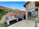Backyard patio with lush greenery, bench seating, and access to the house at 224 Silver Castle St, Las Vegas, NV 89144