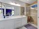 Modern bathroom features double sinks, spacious shower with seating, and large mirror at 224 Silver Castle St, Las Vegas, NV 89144