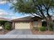 Charming single-story home featuring a two-car garage, desert landscaping, and a beautiful mature shade tree at 224 Silver Castle St, Las Vegas, NV 89144