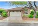 Inviting front exterior with a two-car garage, desert landscaping, and a large window for natural light at 224 Silver Castle St, Las Vegas, NV 89144