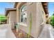 Charming exterior of a home with an arched window, desert landscaping, and an attached two-car garage at 224 Silver Castle St, Las Vegas, NV 89144