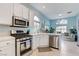 Bright kitchen with stainless steel appliances, white cabinetry, and breakfast nook area at 224 Silver Castle St, Las Vegas, NV 89144