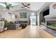Bright living room featuring a fireplace, hardwood floors, and a ceiling fan at 224 Silver Castle St, Las Vegas, NV 89144