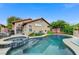 Backyard pool and attached spa with a tanning shelf, ideal for enjoying the outdoors and entertaining at 224 Silver Castle St, Las Vegas, NV 89144