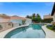 Beautiful backyard pool with a sparkling surface, surrounded by lush landscaping for privacy and serenity at 224 Silver Castle St, Las Vegas, NV 89144