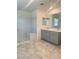 Bright bathroom with double sinks, a walk-in shower, and neutral finishes at 2444 Padulle Pl, Henderson, NV 89044