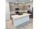 Modern kitchen with stainless steel appliances, a large island, and quartz countertops at 2444 Padulle Pl, Henderson, NV 89044