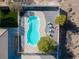 Aerial view of the private in-ground pool with a covered patio and lounge chairs at 2500 S Zephyr Ave, Pahrump, NV 89048