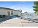 A backyard pool and patio, with a white fence, offer an ideal spot for relaxing at 2500 S Zephyr Ave, Pahrump, NV 89048