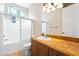 Bathroom showcasing a tub and shower combo with sliding doors and decorative vanity at 2500 S Zephyr Ave, Pahrump, NV 89048