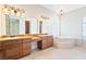 Primary bathroom with double sinks, granite counters, a soaking tub, and a glass enclosed shower at 2500 S Zephyr Ave, Pahrump, NV 89048
