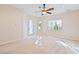 Spacious bedroom featuring a ceiling fan, neutral tones, and natural light from two windows at 2500 S Zephyr Ave, Pahrump, NV 89048