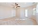 Spacious bedroom with neutral carpet, ceiling fan, closet, and exterior access at 2500 S Zephyr Ave, Pahrump, NV 89048