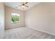 Bright bedroom with ceiling fan, window, and neutral carpet at 2500 S Zephyr Ave, Pahrump, NV 89048
