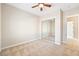 Neutral bedroom featuring mirrored closet doors, soft carpeting, and ceiling fan fixture at 2500 S Zephyr Ave, Pahrump, NV 89048