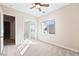 Bedroom featuring large window, ceiling fan, and mirrored closet at 2500 S Zephyr Ave, Pahrump, NV 89048
