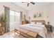 Beautiful staged bedroom with natural light, wood furnishings, and botanical art at 2500 S Zephyr Ave, Pahrump, NV 89048