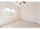 Bright bedroom featuring a window and neutral carpeting at 2500 S Zephyr Ave, Pahrump, NV 89048