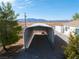 View of carport featuring gravel flooring and metal top with mountain views in the background at 2500 S Zephyr Ave, Pahrump, NV 89048