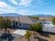 Exterior of home with desert landscaping, three-car garage, mountains in the background at 2500 S Zephyr Ave, Pahrump, NV 89048