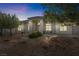 Attractive home boasting an arched entryway, manicured landscaping, and plentiful outdoor lighting at 2500 S Zephyr Ave, Pahrump, NV 89048