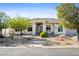 Charming single-story home with a stucco exterior, arched windows, and desert landscaping at 2500 S Zephyr Ave, Pahrump, NV 89048
