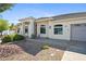 Single-story home featuring desert landscaping, an arched entryway, and a two-car garage at 2500 S Zephyr Ave, Pahrump, NV 89048