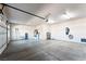 The expansive three-car garage features built-in storage and bright overhead lighting at 2500 S Zephyr Ave, Pahrump, NV 89048