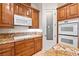 Built-in oven and a stovetop are featured along the granite countertops and custom cabinets in the kitchen at 2500 S Zephyr Ave, Pahrump, NV 89048