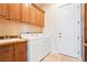 Functional laundry room with side-by-side washer and dryer, utility sink, and plenty of storage at 2500 S Zephyr Ave, Pahrump, NV 89048