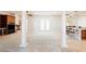 Bright open-plan living room featuring columns, a fireplace, and access to the kitchen area at 2500 S Zephyr Ave, Pahrump, NV 89048